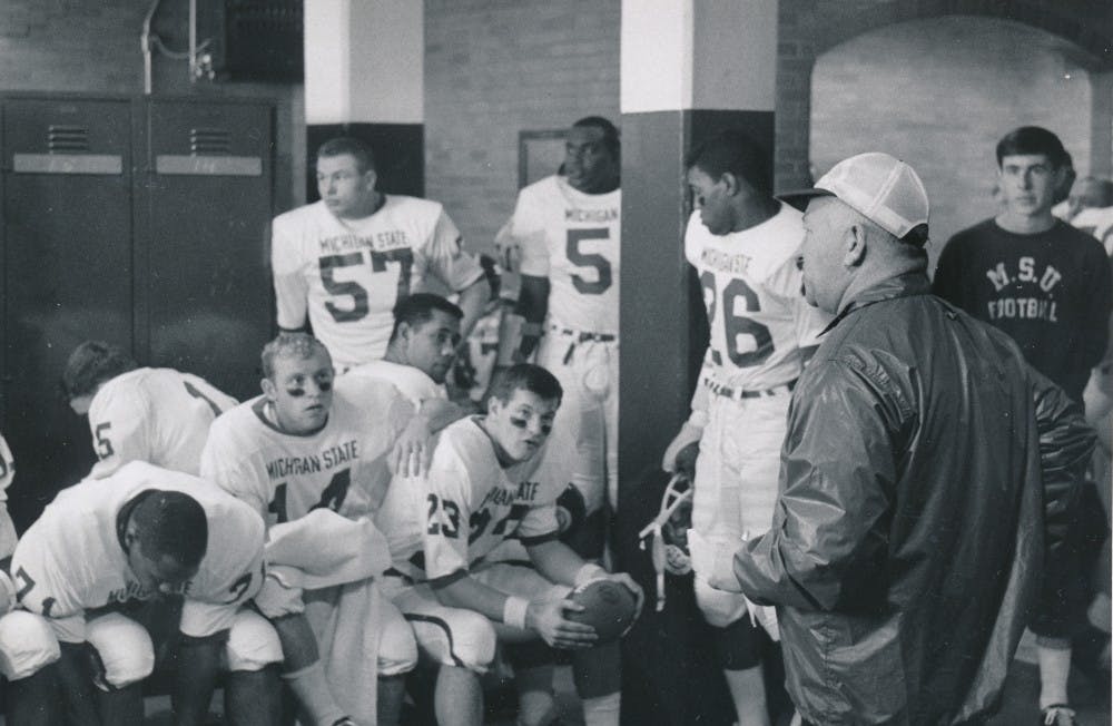 Then head coach Duffy Daugherty addresses his team in the locker room before a game during the 1965 football season. The Spartans went on to win the national title that year. Photo courtesy MSU Athletic Communications. 