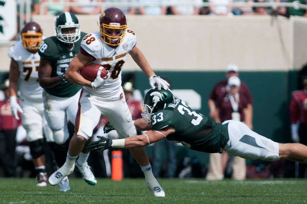 Sophomore linebacker Jon Reschke tries to tackle Central Michigan wide receiver Jesse Kroll in the second quarter during the game against Central Michigan on Sept. 26, 2015, at Spartan Stadium. The Spartans defeated the Chippewas, 30-10. Julia Nagy/The State News 