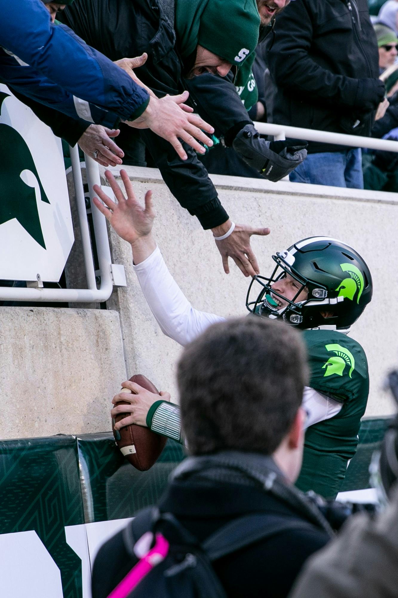 <p>Redshirt senior quarterback Brian Lewerke (14) celebrates during the game against Illinois on Nov. 9, 2019 at Spartan Stadium.</p>