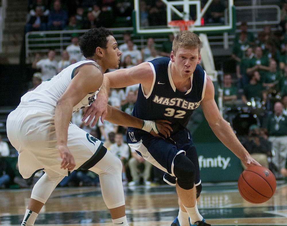 <p>Junior guard Bryn Forbes defends The Master's College guard Russell Byrd on Nov. 3, 2014 at the Breslin Center. The Spartans defeated the Mustangs, 97-56. Aerika Williams/The State News.</p>