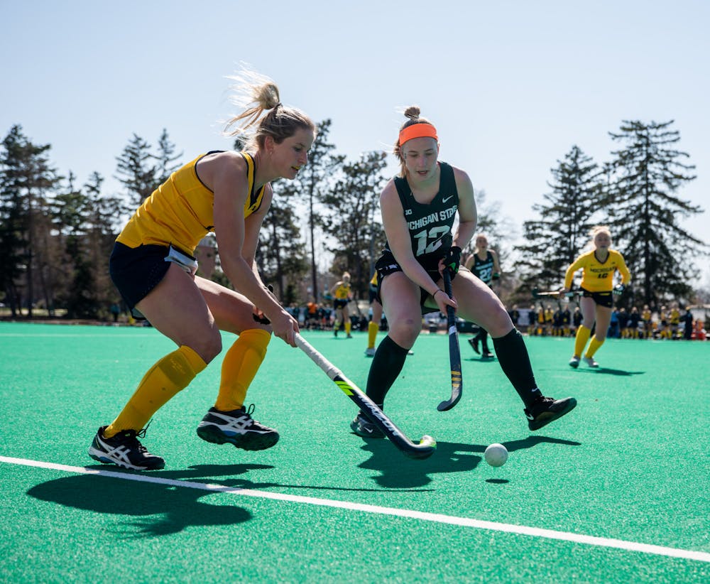 MSU junior Isa Van Der Weij, right, battles for possesion against Michigan senior Kayla Reed, left, during a game on Ralph Young Field on April 2, 2021.