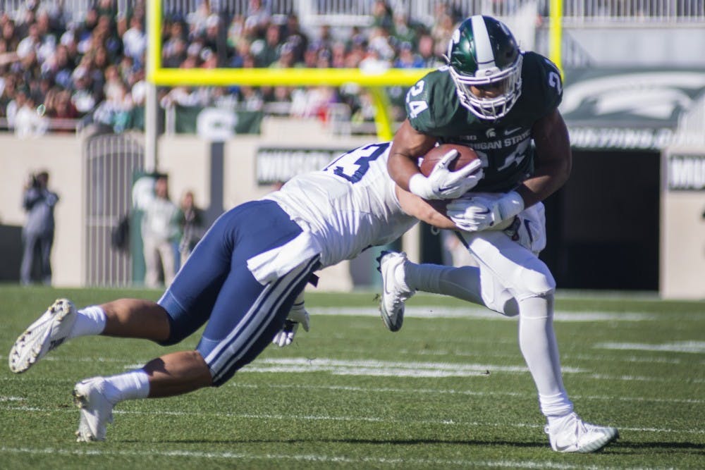 Junior running back Gerald Holmes (24) runs through a missed tackle by Brigham Young linebacker Francis Bernard (13) during the game against Brigham Young University on Oct. 8,  2016 at Spartan Stadium. 
