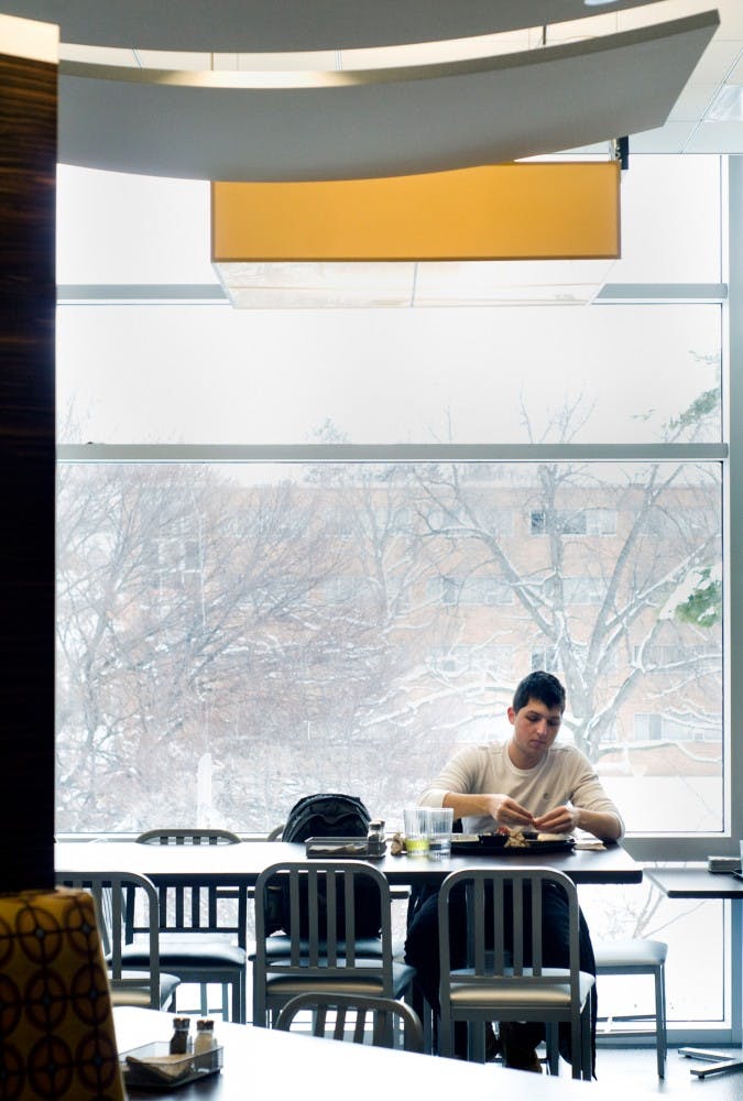 Finance freshman Tony Yizze eats lunch Monday afternoon at Brody Square. The Brody Neighborhood recently underwent a series of renovations that has not only improved the complex's image, but also the number of students signed up to live there come next year. Matt Hallowell/The State News