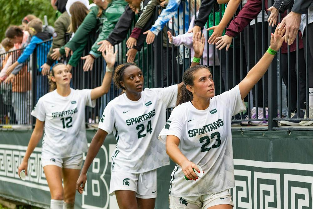 <p>Michigan State women's soccer players Bella Najera (23), Kennedy Bell (24) and Mackenzie Kruer (12), walk along the stands of DeMartin Stadium thanking fans who stayed through the rain in East Lansing, Mich., on Sept. 20, 2026.</p>