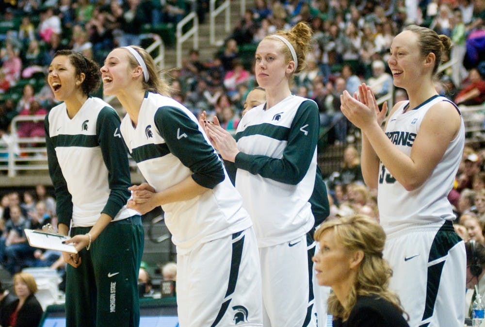 Teammates cheer from the bench after an MSU basket Sunday at Breslin Center. The Spartan win made their season record 18-2, 6-1 in the Big Ten. Kat Petersen/The State