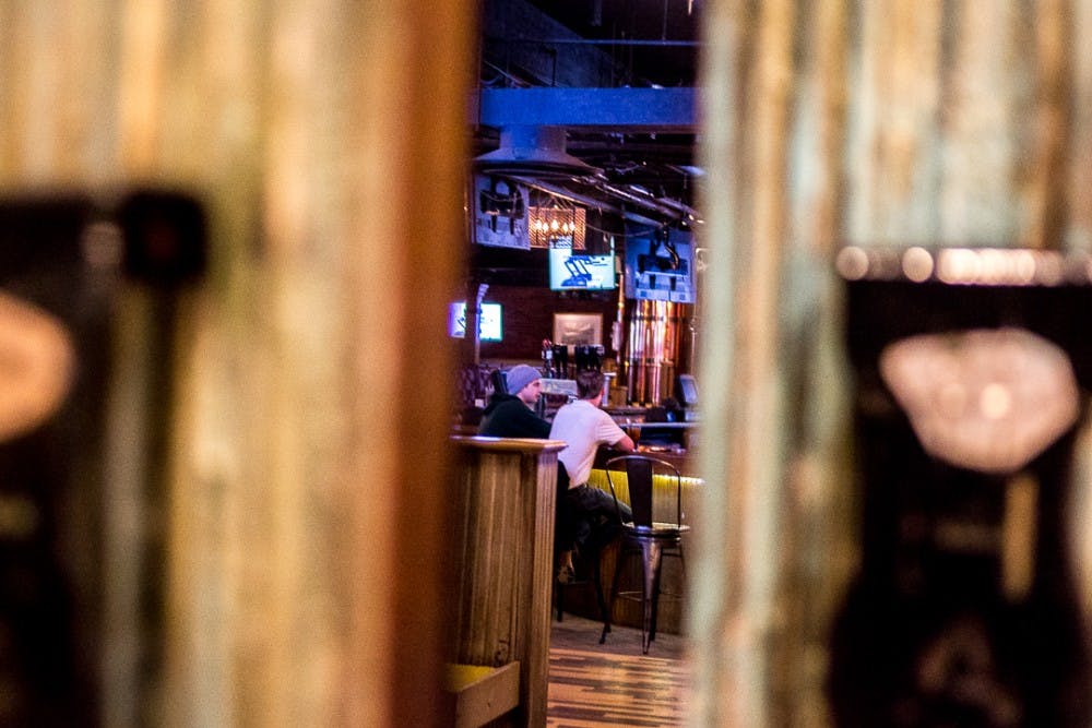 Two men sit in Harper's Restaurant and Brew Pub on Feb. 6, 2018 at 131 Albert Ave, East Lansing.  