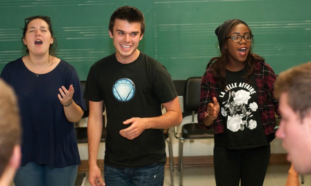 <p>From left to right, apparel and textiles senior Emily Semroc, marketing junior Joseph Wylie and media and information freshman Shanice Pinson sing a song during a State of Fifths practice on Sept. 27, 2015 in the Music Building. "The people in the group are so great," Pinson said. "They're going to be my best friends." Joshua Abraham/The State News</p>