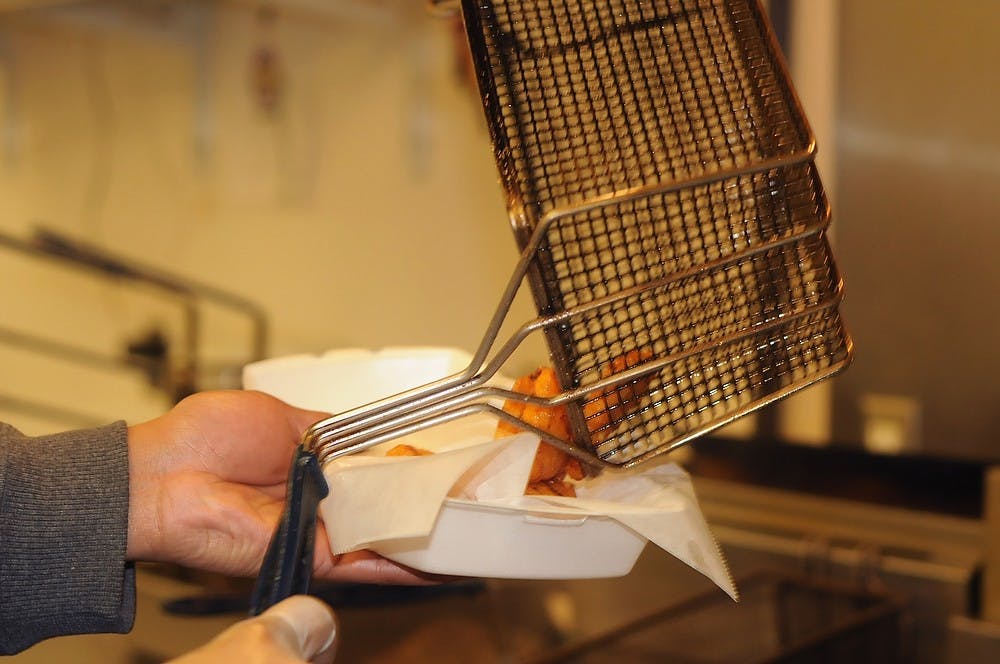 <p>Conrad's College Town Grill manager Chris Sonie takes Mac & Cheese Bites off the fryer Feb 4, 2015, at Conrad's College Town Grill 1219 E Grand River Ave, East Lansing. Kennedy Thatch/The State News.</p>