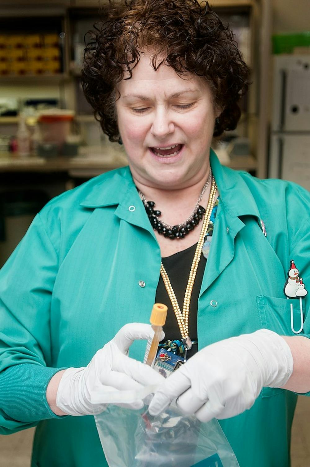 	<p>East Lansing resident Laura Mann, a medical technologist at Olin Health Center, processes specimens Wednesday inside Olin’s laboratory. </p>