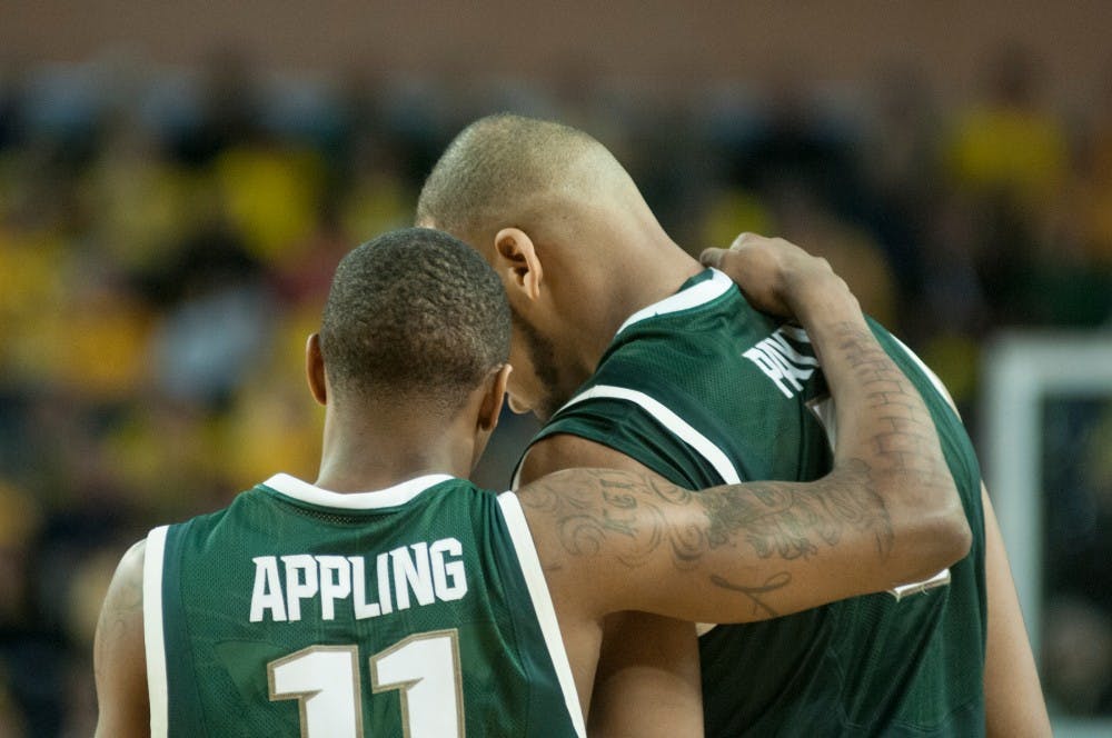 	<p>Senior guard Keith Appling converses with senior center Adreian Payne during the game against Michigan on Feb. 23,  2014, at Crisler Center in Ann Arbor, Mich. The Spartans were defeated by the Wolverines, 79-70. Danyelle Morrow/The State News</p>