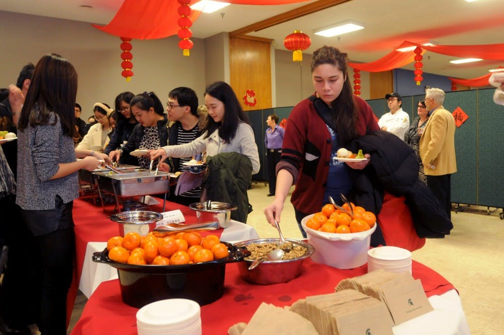 Journalism junior Natasha Blakely gets food during a Chinese New Year celebration on Feb. 5, 2016 at Shaw Hall. Traditional cuisine was served for the guests.