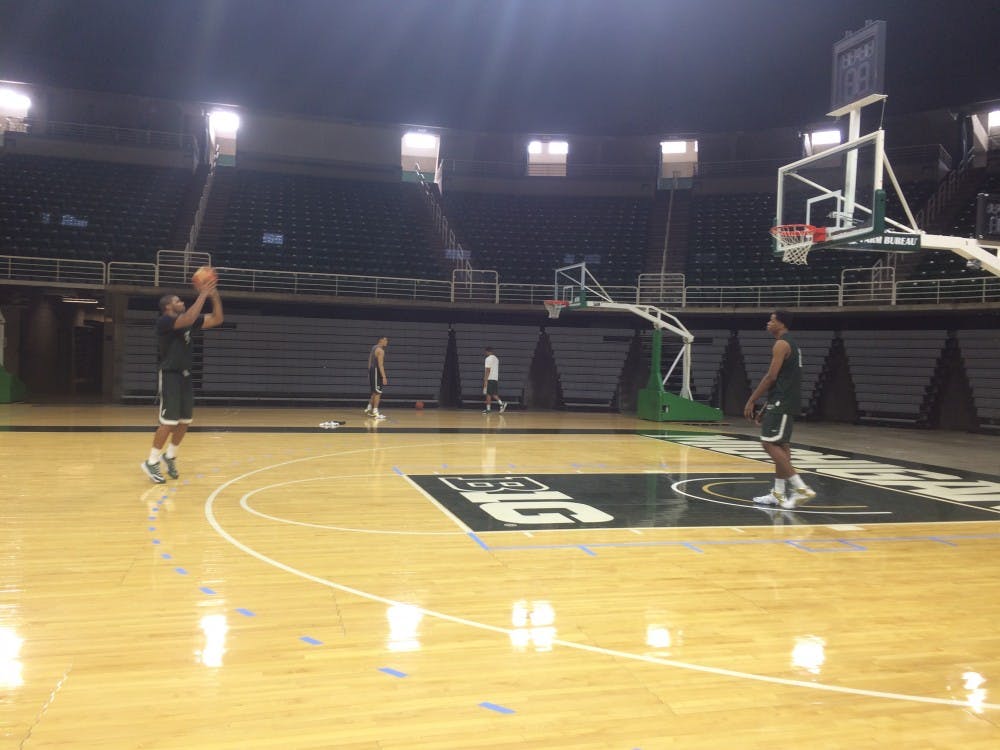 <p>Sophomore forward Marvin Clark shoots an international FIBA ball from a taped-on professional three-point line, as freshman forward Deyonta Davis prepares for the rebound on Aug. 19, 2015 at the Jack Breslin Student Event Center. Ryan Kryska/The State News</p>