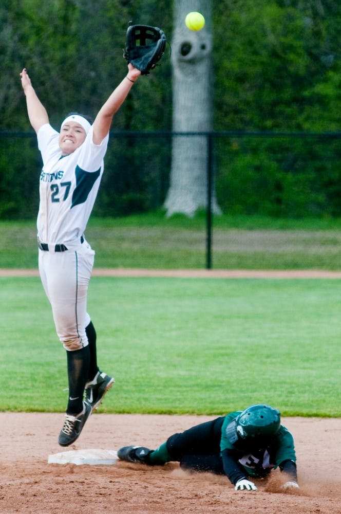 Junior shortstop Raime Cronkhite misses the ball as an Eastern Michigan player slides into second base when facing EMU Wednesday afternoon at Secchia Stadium. The Spartans lost to the Eagles 6-3. Samantha Radecki/The State News