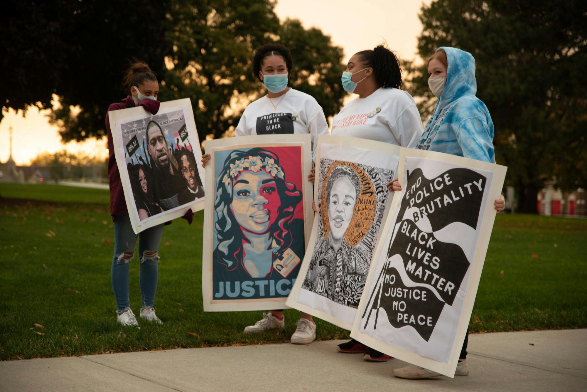 <p>7 Miles for 7 Shots March participants holding &quot;Justice for Breonna&quot; signs at the Michigan State Capital on Friday, October 16, 2020. </p>