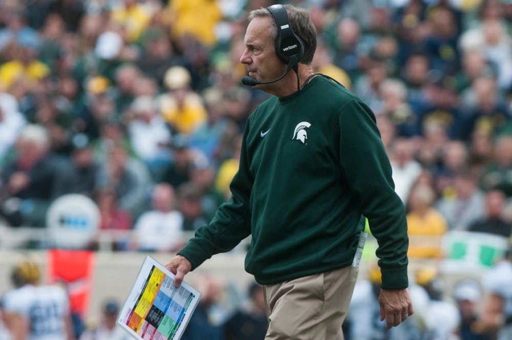 Head coach Mark Dantonio walks back to the sidelines after talking with the team during a time out during the game against Michigan on Oct. 29, 2016 at Spartan Stadium. The Spartans were defeated by the Wolverines, 32-23.