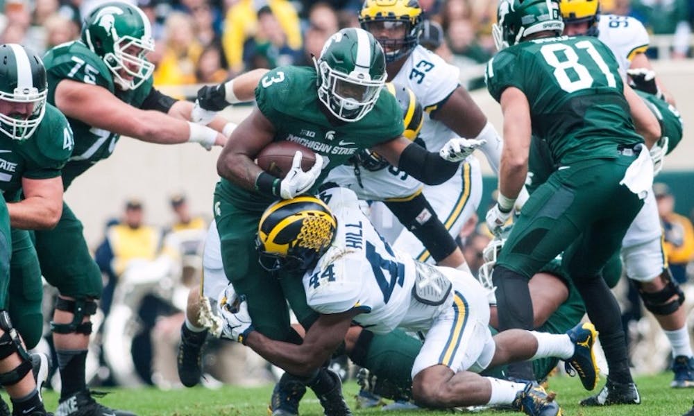 Sophomore running back LJ Scott (3) runs the football during the game against the University of Michigan on Oct. 29, 2016 at Spartan Stadium. The Spartans were defeated by the Wolverines, 32-23.