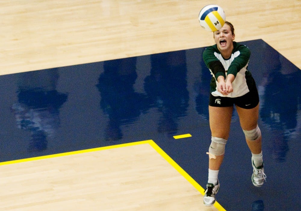 Freshman libero Kori Moster serves the ball against U-M. The Spartans lost to the Wolverines, 3-1, on Wednesday evening at Cliff Kreen Arena in Ann Arbor. Josh Radtke/The State News