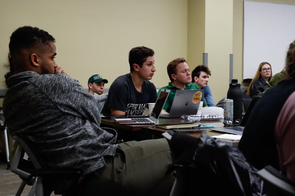 <p>Michigan State ASMSU representative within the general assembly Jonah Attia listens after he yields to Michigan State ASMSU member Alan Saleh. The ASMSU Elections were held in the Student Services Building Conference Room, on April 20, 2022, with Michigan State junior Jordan Kovach becoming the next ASMSU President.</p>