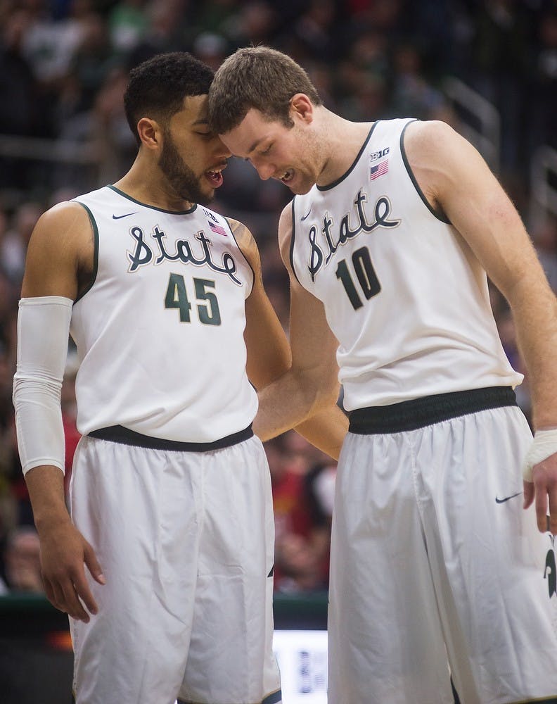 <p>Junior guard Denzel Valentine, 45, talks with junior forward Matt Costello during the game against Maryland on Dec. 30, 2014, at Breslin Center. The Spartans were defeated by the Terrapins, 68-66 in double overtime. Danyelle Morrow/The State News</p>
