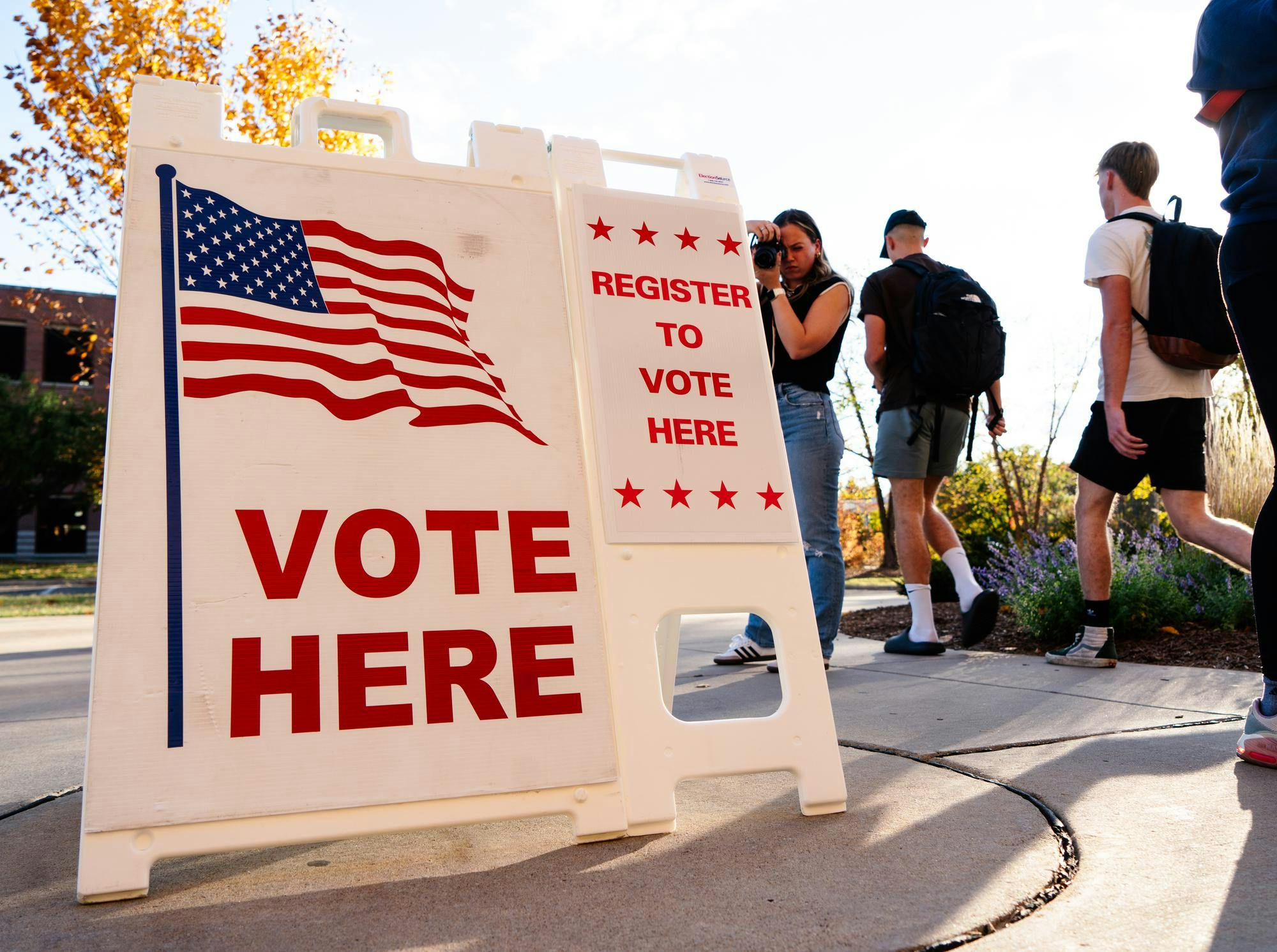 Students walk out of the Communication Arts and Sciences building, where early voting is taking place in the WKAR studio on Oct. 23, 2024. 