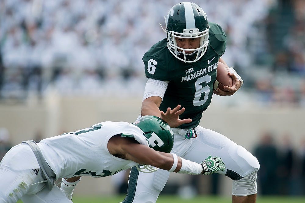<p>Eastern defensive back DaQuan Pace tackles redshirt freshman quarterback Damion Terry on Sept. 20, 2014, at Spartan Stadium. The Spartans defeated the Eagles, 73-14. Julia Nagy/The State News</p>