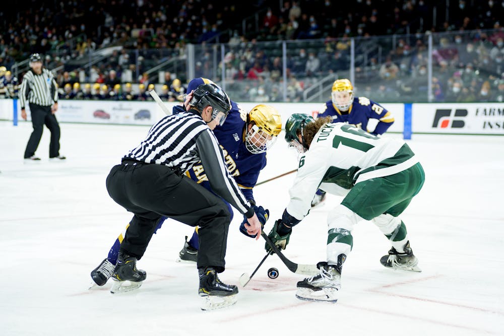 <p>Michigan State freshman Jesse Tucker in a face off against Notre Dame junior Solag Bakich on Feb. 19, 2022. Spartans lose 4-2 against Notre Dame.</p>