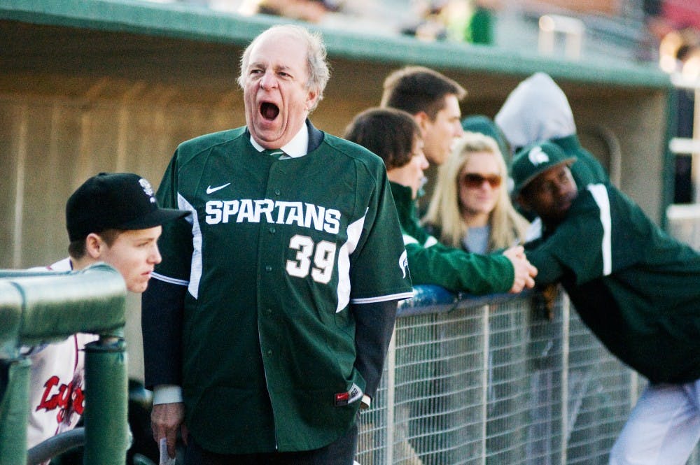 East Lansing Mayor Vic Loomis yawns while waiting on the sidelines for the Crosstown Showdown to begin Tuesday at Cooley Law School Stadium in Lansing. The MSU baseball team took on the Lansing Lugnuts for their yearly rivalry. Kat Petersen/The State News