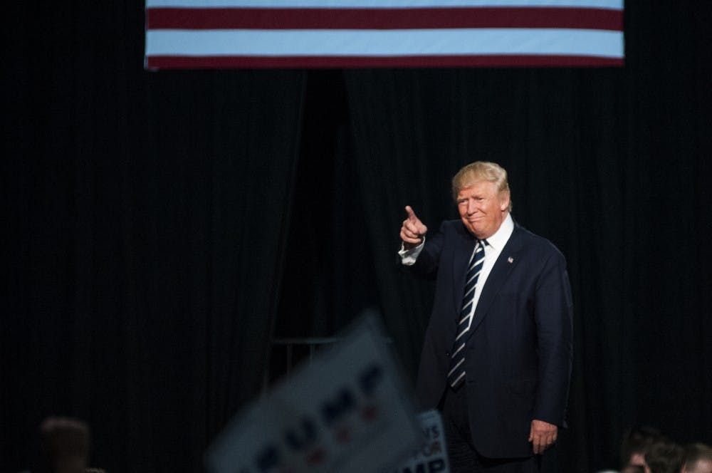 Republican presidential nominee Donald Trump points to the crowd after finishing his speech on Nov. 7, 2016 at DeVos Place Convention Center in Grand Rapids, Mich. The DeVos Place Convention Center was Trump's last stop for the 2016 election season.