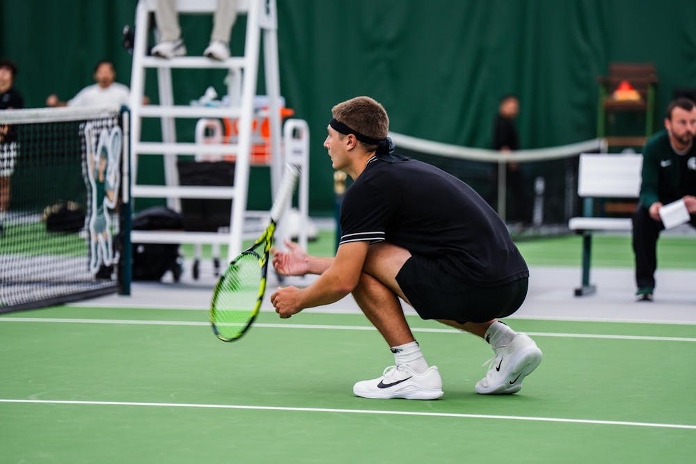 <p>Mitchell Sheldon, a Michigan State sophomore, ducks as his doubles partner prepares to serve, spinning his racket while waiting during a match at the MSU Tennis Center in Lansing, Mich., Sunday, April 19, 2026.</p>