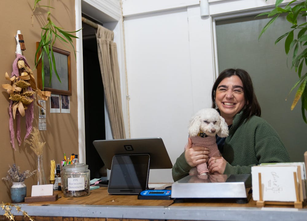 <p>The Clean Refillery Owner Alexa Hecksel poses with her dog Winnie on Jan. 13, 2022. Clean Refillery is a low waste refill shop for daily home and self care necessities in Lansing, Michigan.</p>