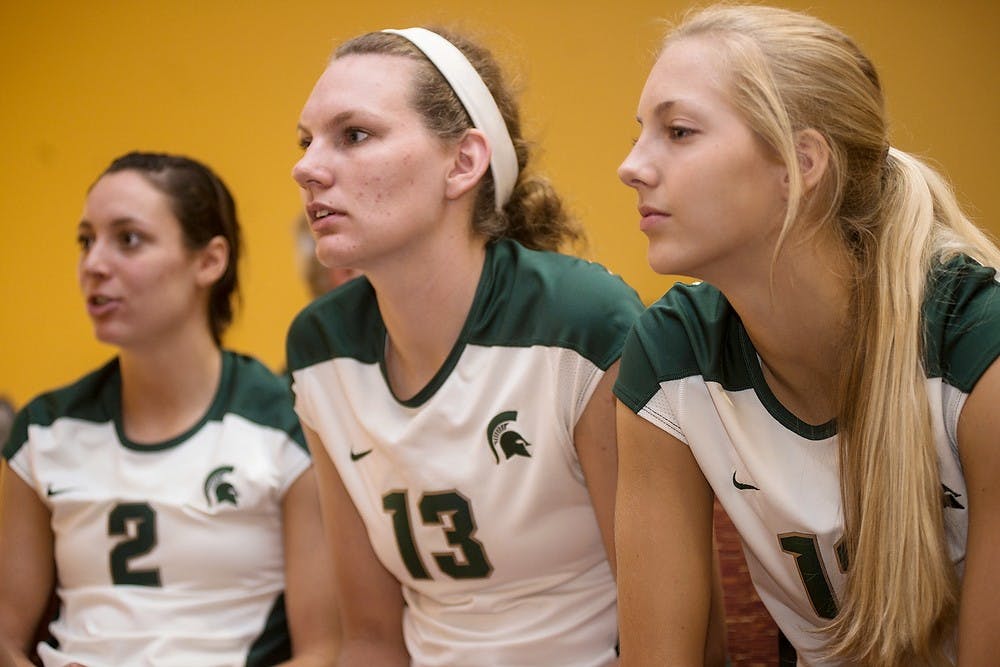 <p>Redshirt sophomore defensive specialist Kristen Muir, left, redshirt freshman middle backer Brooke Kranda and freshman setter Rachel Minarick talk with their teammates during volleyball media day at  Spare Time Entertainment Center in Lansing on August 22, 2014. Erin Hampton/The State News</p>