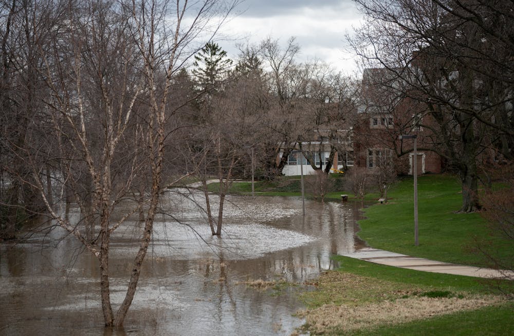 The Red Cedar River floods the sidewalk after heavy rainfall on campus on April 5, 2023. 
