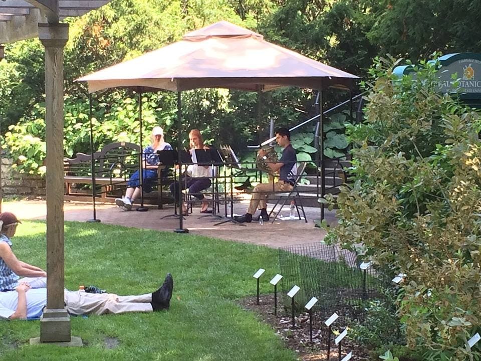 <p>Clair Ross &amp; Matthew Sedatole performing a Horn Duo for the audience in the W.J. Beal Botanical Garden at lunchtime on Friday, July 24. Photo Courtesy of the Peter Carrington, assistant curator of the Garden. </p>