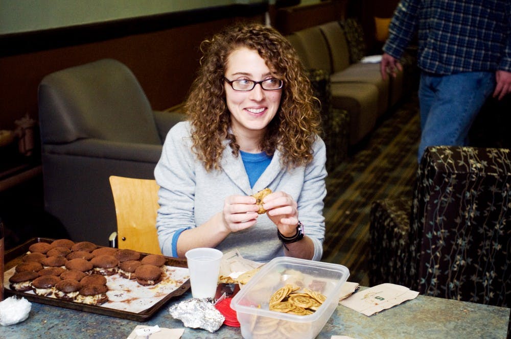 	<p>Food science senior Lily Franklin digs into another cookie Thursday in the basement of Mason Hall. Franklin entered German chocolate cake woopie pies and cinnamon roll cookies into the <span class="caps">MSU</span> Cookie Club&#8217;s cookie competition.</p>