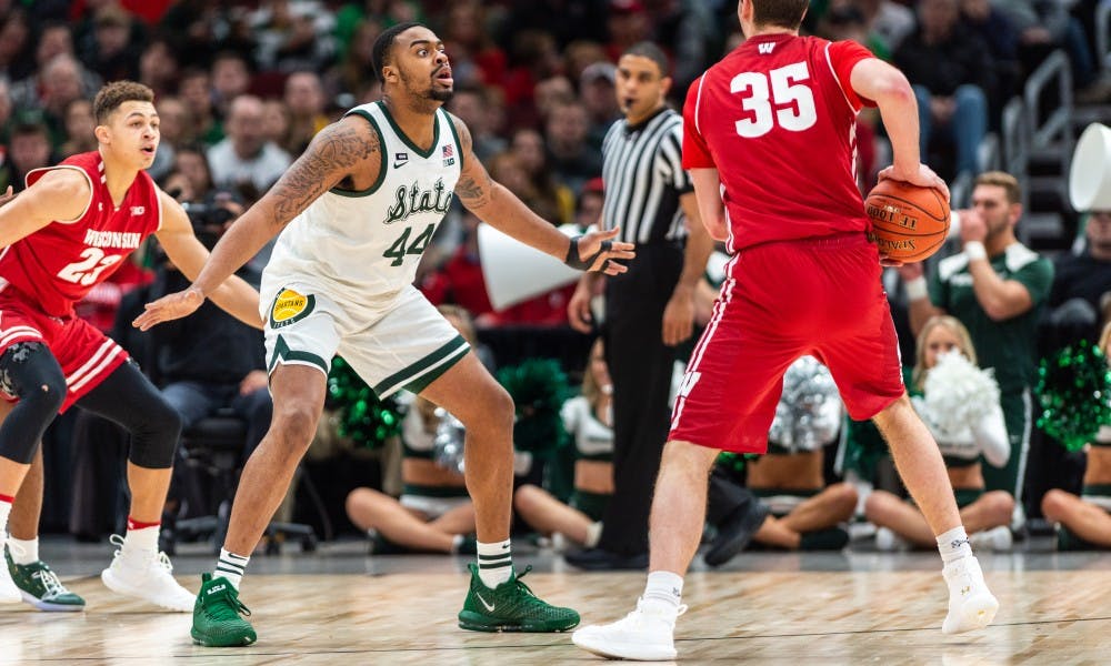 Junior forward Nick Ward (44) defends Wisconsin's Nate Reuvers. The Spartans beat the Badgers, 67-55, at the United Center on March 16, 2019.