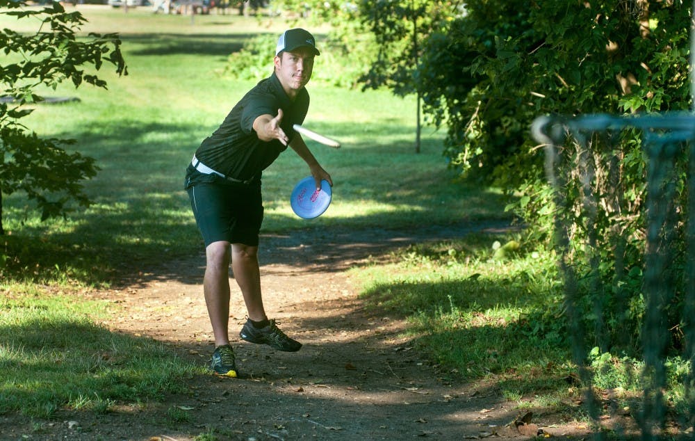 Professional disc golfer Paul Ulibarri, from Pheonix, Ariz., throws a disc while competing in the CCR Open at the disc golf course in Grand Woods Park, 4500 River Ridge Rd., in Lansing, on Sunday, Aug. 12, 2012. Ulibarri took first place in the tournament that was put on by the Capital City Renegades Disc Golf Club. Samantha Radecki/The State News