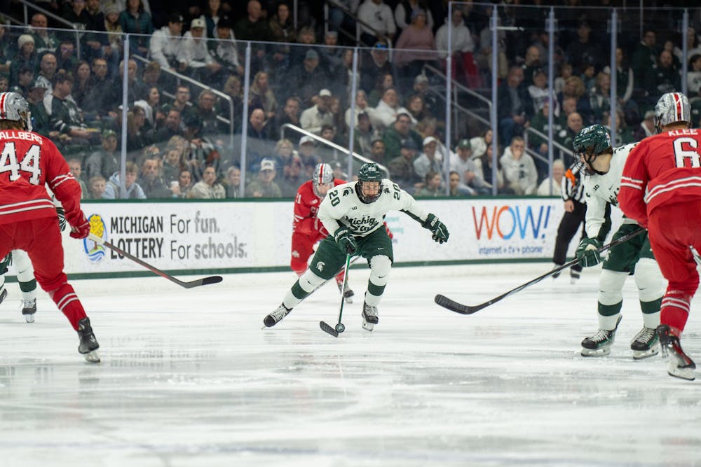<p>Sophomore forward Daniel Russell (20) carrying the puck forward during a game against Ohio State University at Munn Ice Arena on Feb. 24, 2024.</p>
