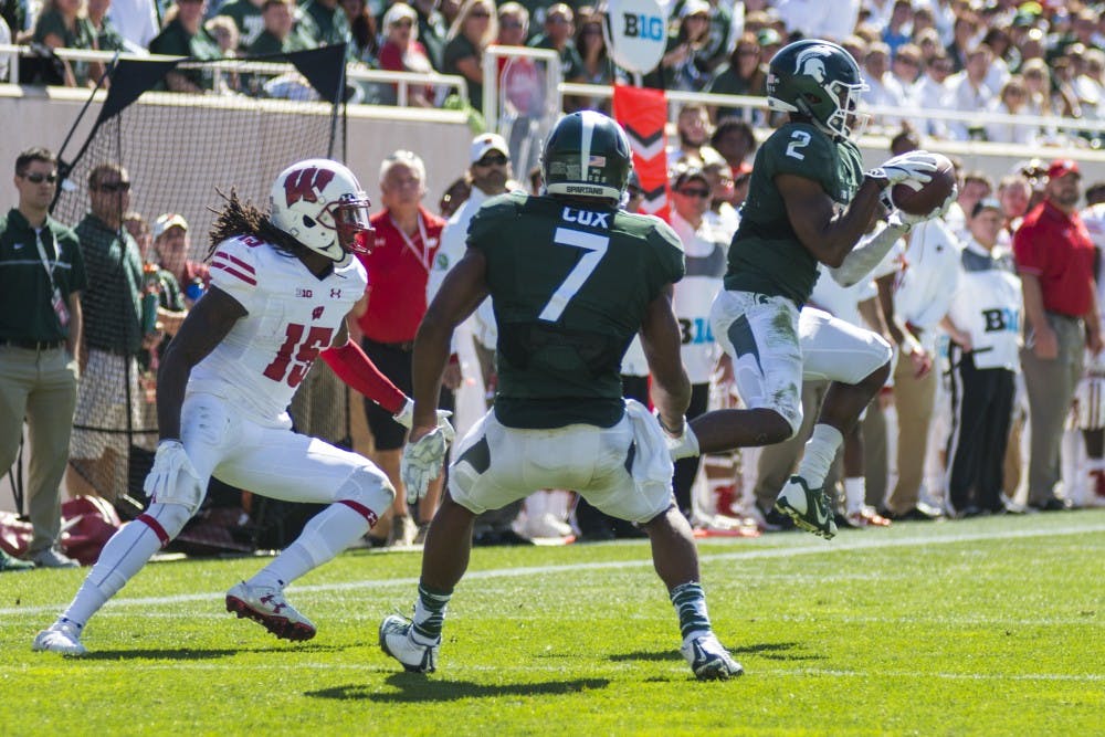 Senior cornerback Darian Hicks (2) intercepts the ball for a pass intended for Wisconsin wide receiver Robert Wheelwright (15) during the last play of the second quarter  against Wisconsin on Sept. 24, 2016 at Spartan Stadium. 