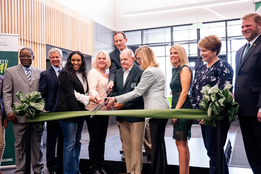 Ribbon cutting of the newly renovated Packaging building on Apr. 20, 2023, in the Charles L.& Jacqueline C. Fraiser Atrium. 