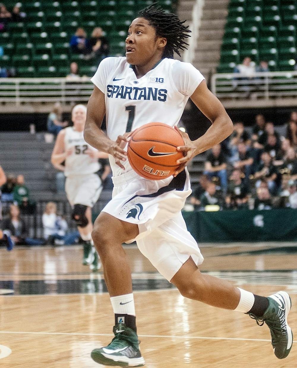 Senior guard Jasmine Thomas runs the ball on a fast break Nov. 4, 2012, at Breslin Center. Thomas finished with 15 points during a 83-36 victory over Grand Valley State in the second and final exhibition game of the season. Adam Toolin/The State News