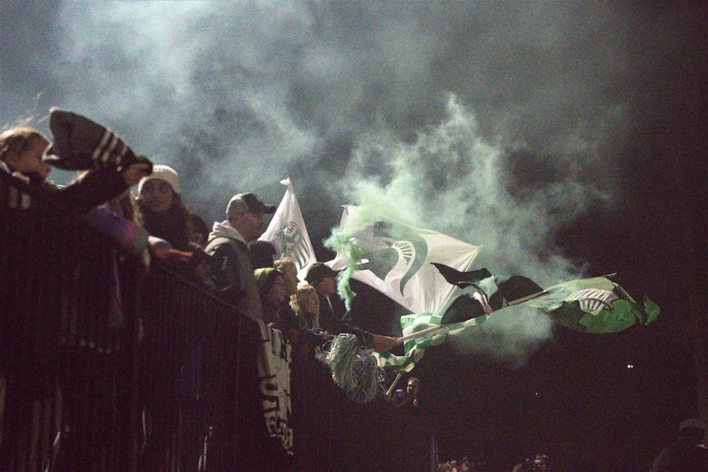 <p>Fans set off ﻿smoke bombs in the stands in celebration of the tough match between the Spartans and the Milwaukee Panthers on Nov. 11, 2022. The Spartans won 3-2 in a double overtime. </p>