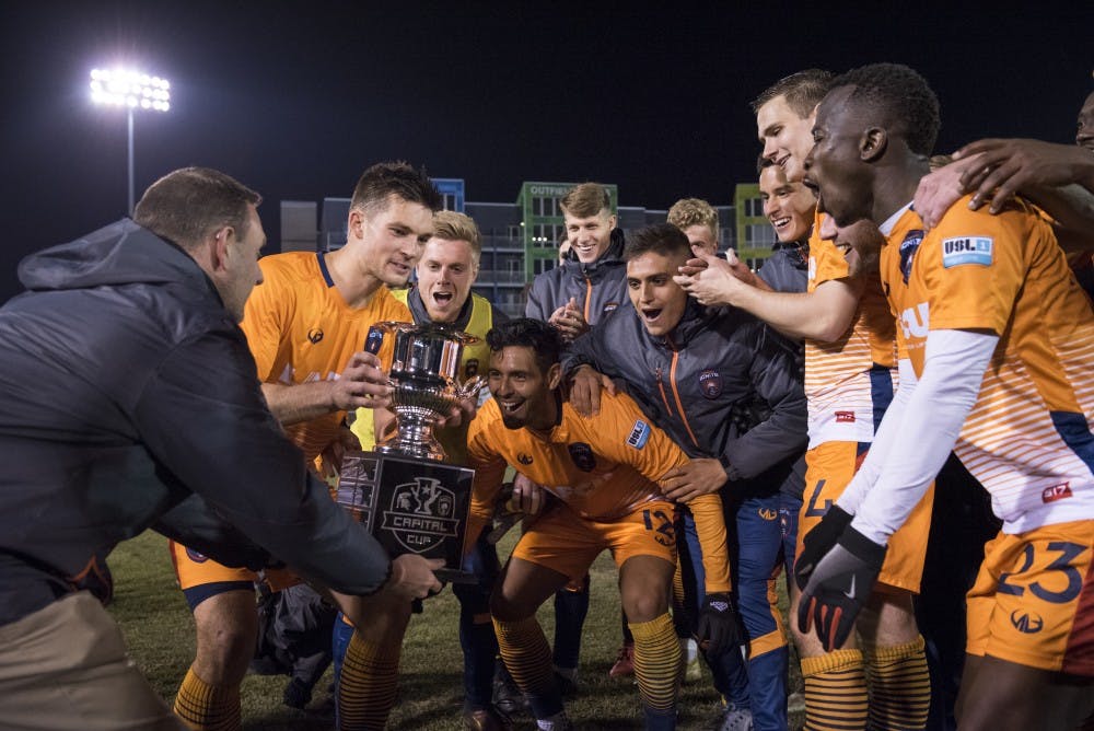 Lansing Ignite celebrates receiving the Capital Cup after the Capital Cup game against Michigan State men's soccer team at Cooley Law School Stadium in Lansing on Tuesday, April 16, 2019. Michigan State was defeated by Lansing Ignite, 4-0. (Nic Antaya/The State News)