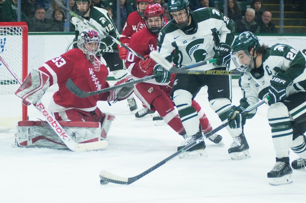 <p>Junior forward Michael Ferrantino takes a shot March 6, 2015, during the game against Wisconsin at Munn Ice Arena. The Spartans defeated the Badgers 3-0. Kennedy Thatch/The State News</p>
