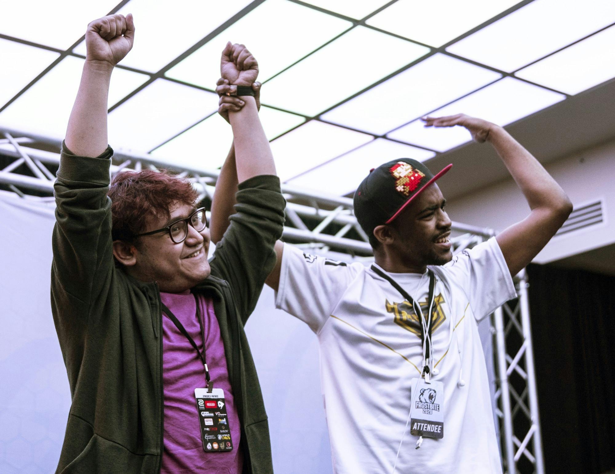 No. 1 MKLeo (left) celebrates his Grand Finals win onstage with No. 22 Dark Wizzy (right) at Frostbite 2020.