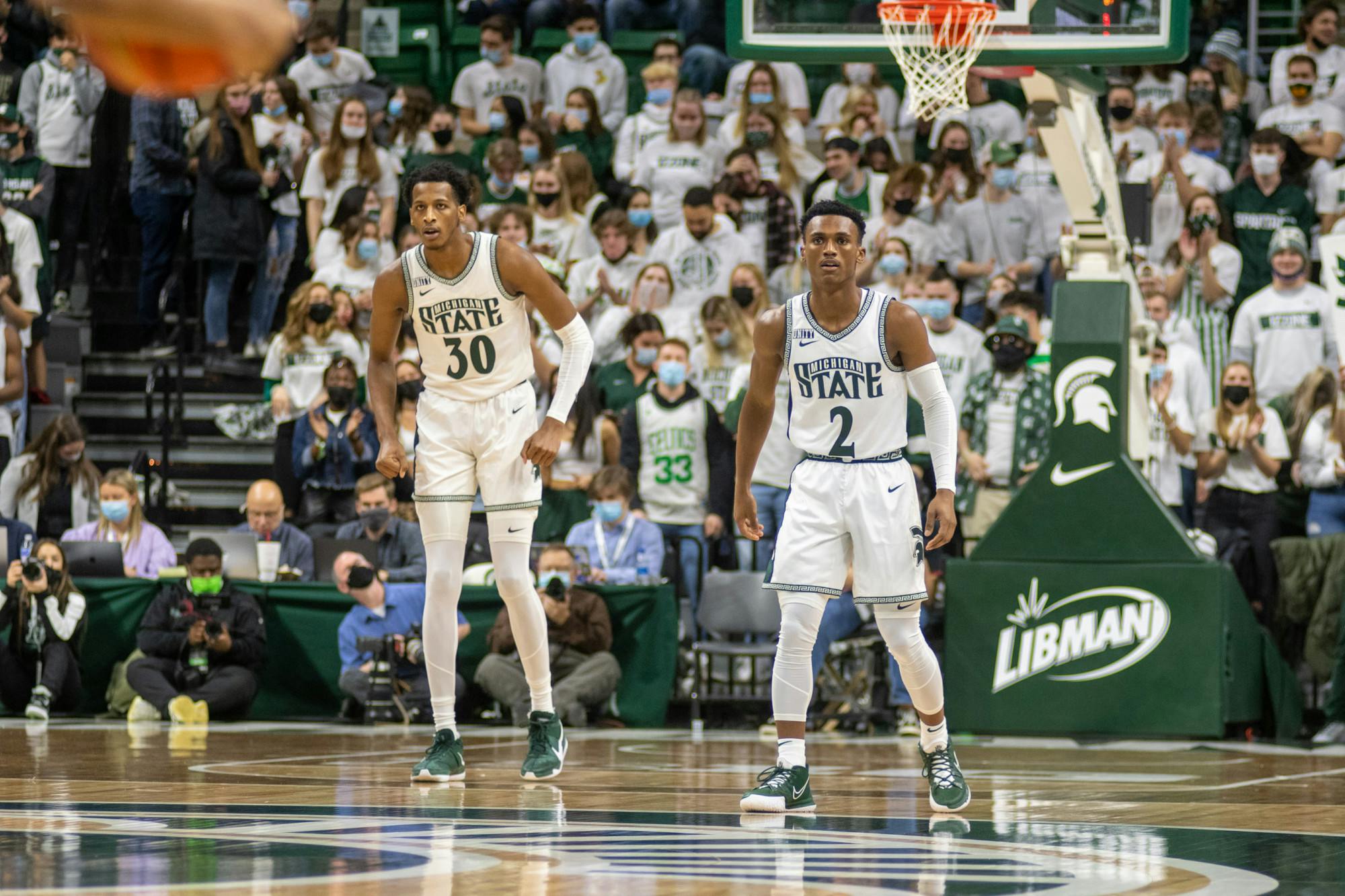 <p>Senior forward Marcus Bingham (30) and junior guard Tyson Walker (2) on the floor for MSU against Eastern Michigan at the Breslin Center in East Lansing on Nov. 20, 2021.</p>