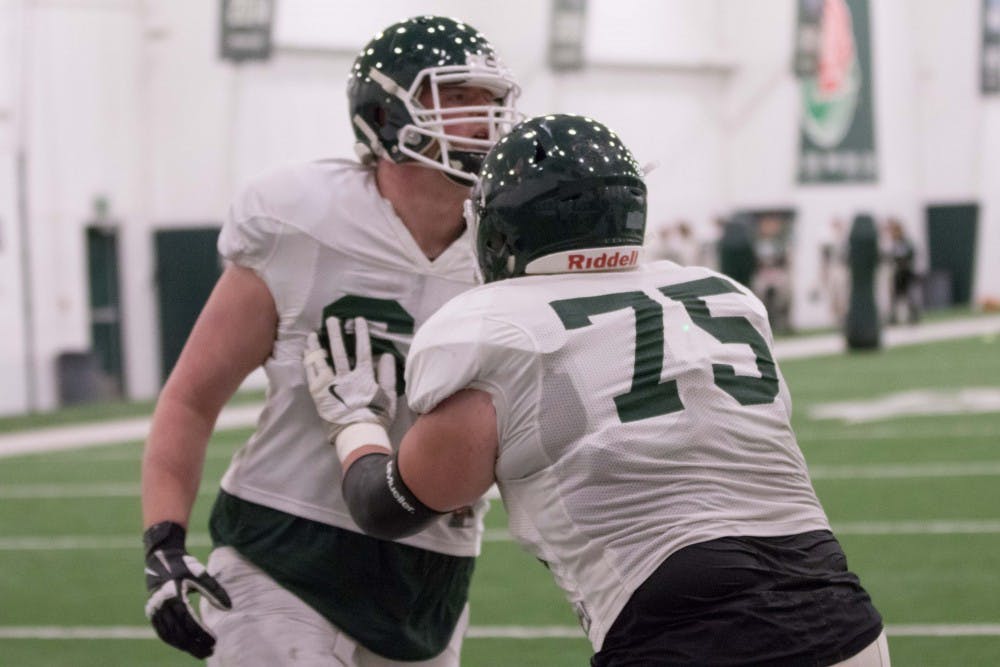 Sophomore offensive guard Kevin Jarvis (75) does a drill during practice on April 3, 2018, inside Duffy Daugherty Football Building.