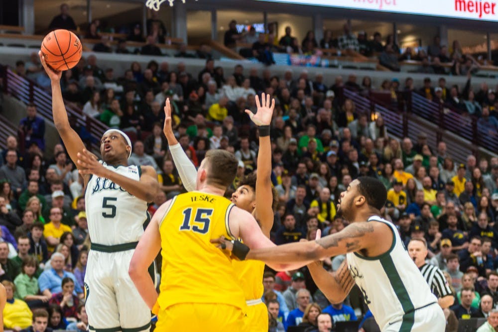 <p>Junior guard Cassius Winston (5) shoots a layup over Michigan&#x27;s Jon Teske. The Spartans beat the Wolverines, 65-60, at the United Center on March 17, 2019.</p>