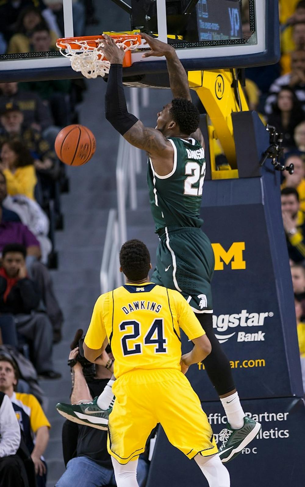 <p>Senior guard/forward Branden Dawson scores a goal Feb. 17, 2015, during the game against Michigan at Crisler Center in Ann Arbor. The Spartans are leading against the Wolverines at halftime, 38-23. Emily Nagle/The State News</p>