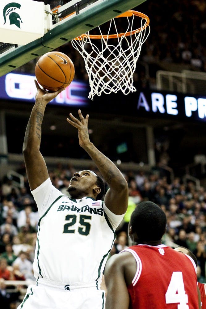 Junior center Derrick Nix gets past Indiana defenders for a layup Wednesday night at Breslin Center. Nix netted 14 points for the Spartans in the 80-65 victory over the Hoosiers. Matt Hallowell/The State News