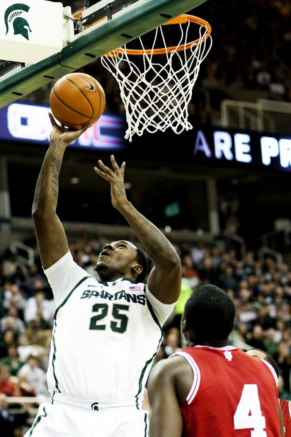 Junior center Derrick Nix gets past Indiana defenders for a layup Wednesday night at Breslin Center. Nix netted 14 points for the Spartans in the 80-65 victory over the Hoosiers. Matt Hallowell/The State News